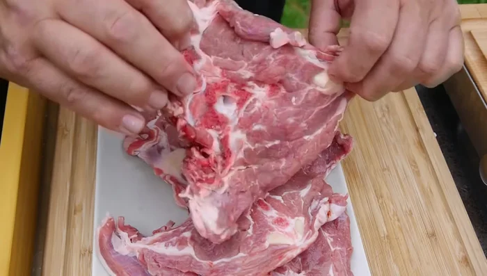 Lamm Nackensteaks in dünne Scheiben schneiden.