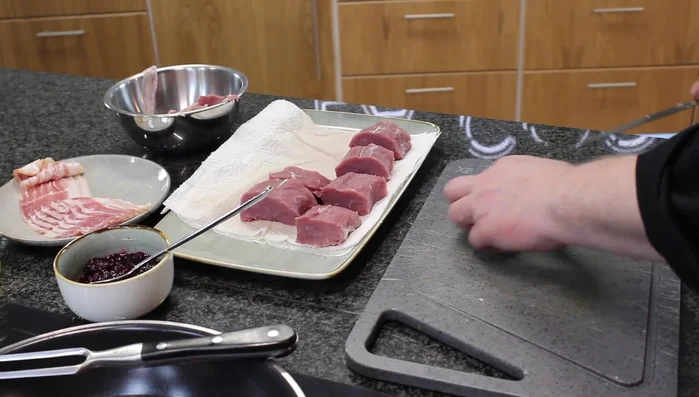 Die Medaillons mit Speck umwickeln und mit Holzspießen fixieren (102.36).