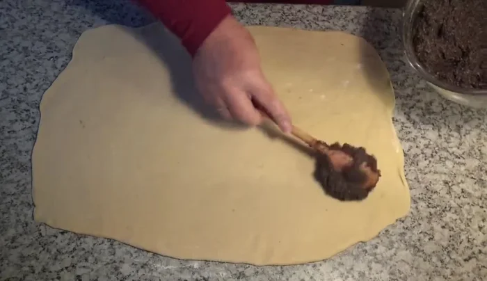 Mohnfülle gleichmäßig auf dem Teig verteilen. [639.279]