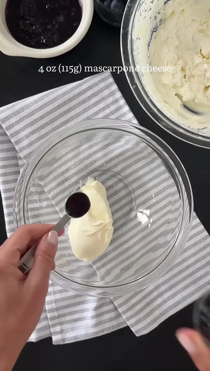 Mascarpone, Vanilleextrakt, Puderzucker verrühren und vorsichtig unter die geschlagene Sahne heben.