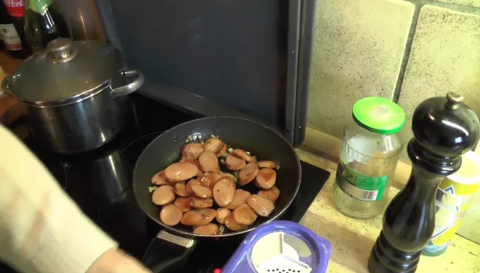 Etwas Mehl in den Bohneneintopf einrühren, um ihn sämig zu machen.