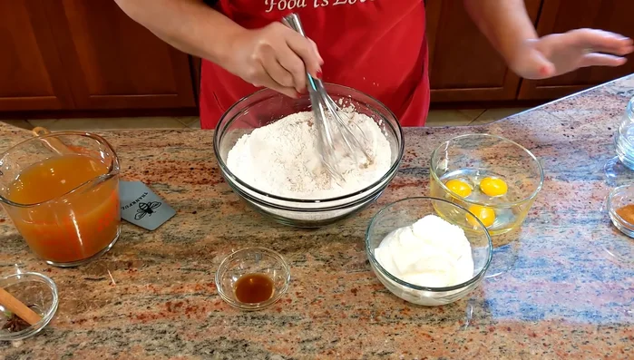 Teig zubereiten: Verquirlte Eier in die trockenen Zutaten geben, dann den Ricotta hinzufügen. Den reduzierten Apfelwein durch ein Sieb in den Teig geben und alles gut verrühren.