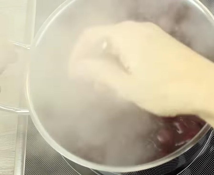 Heiße Kirschmasse auf den ausgekühlten Schokoboden geben und verteilen.