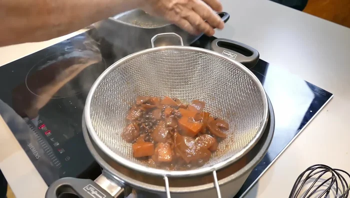 Soße durch ein Sieb passieren (659.769).