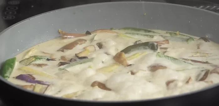 Gewürfelten Tempeh zum Curry geben.