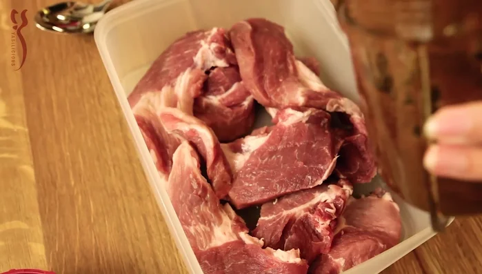 Marinade über das Fleisch geben und gut vermengen. Über Nacht im Kühlschrank marinieren lassen.